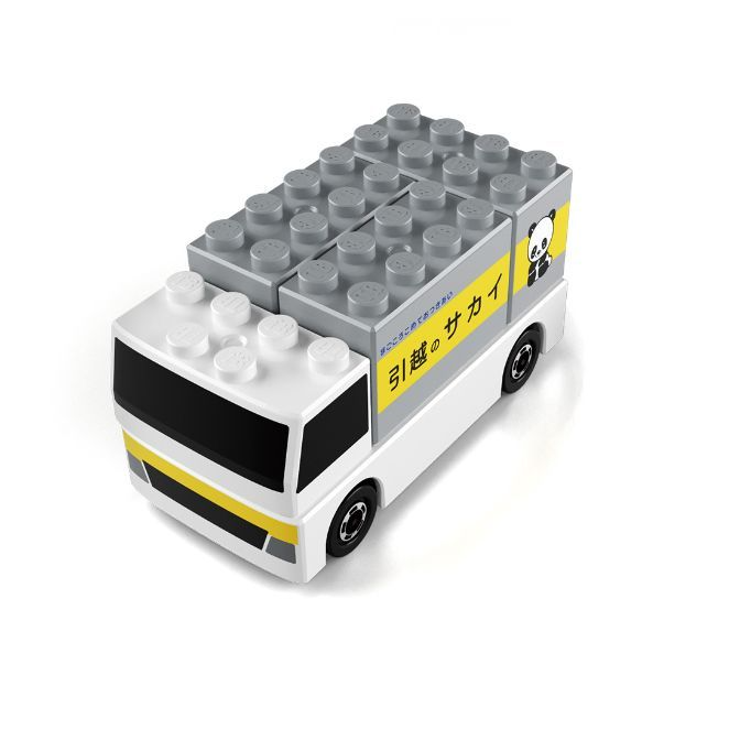 Toy truck made of building blocks, white cab and grey cargo area, with panda logo and Japanese text.