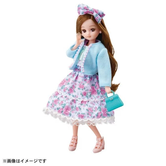  Doll in floral dress, blue jacket, bow headband, and purse.