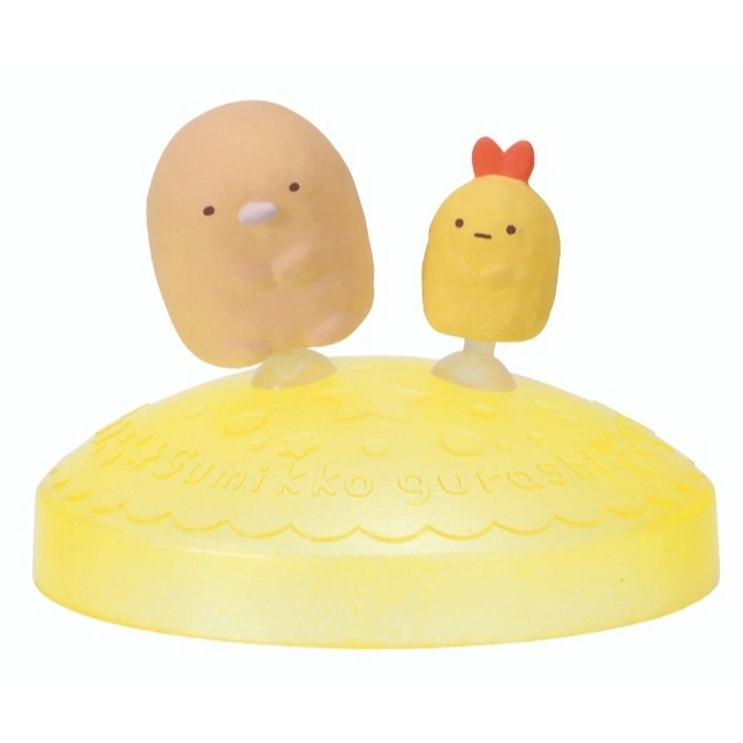 Sumikko Gurashi figurines: a brown blob and a shrimp tempura with a red bow, on a yellow base.