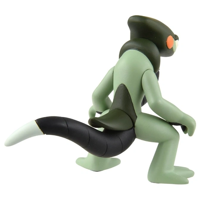  Green and black toy monster with a long tail in a crouching pose.