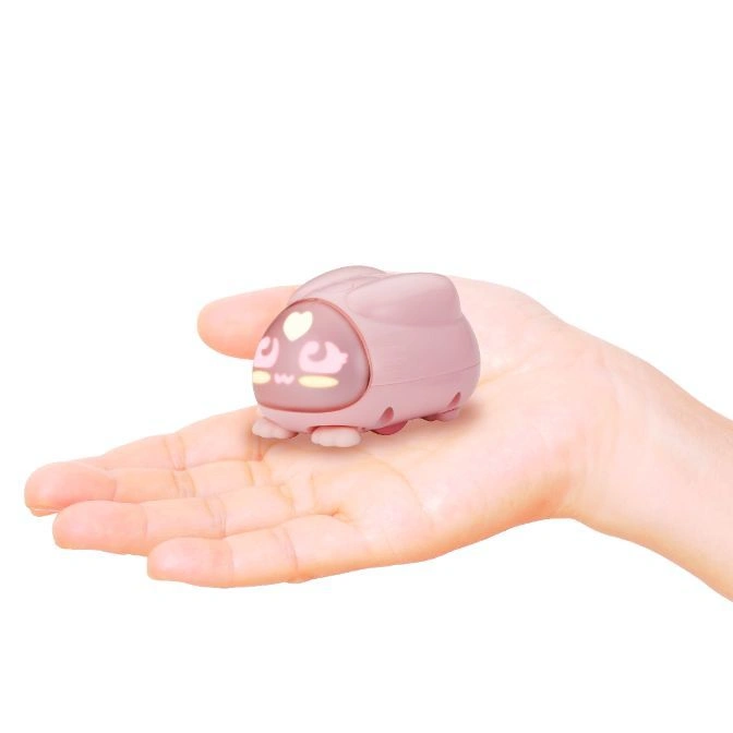 Pink bunny-shaped toy car with a heart on its face resting on a hand.