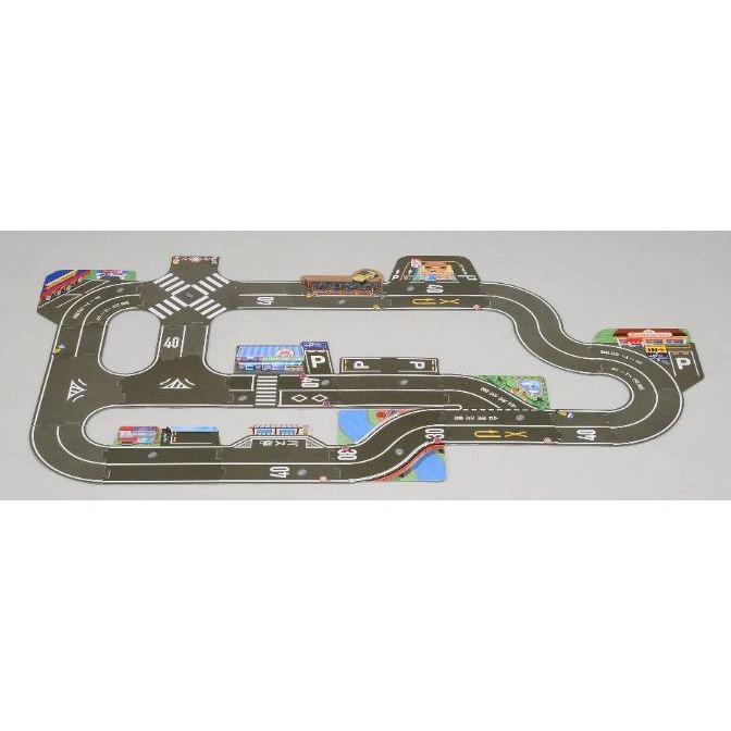 Toy road layout with buildings: gas station, restaurant, convenience store, bus stop, and parking. Speed limits posted.