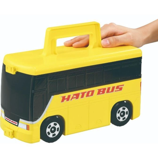  Yellow Hato Bus toy with handle and hand on top.