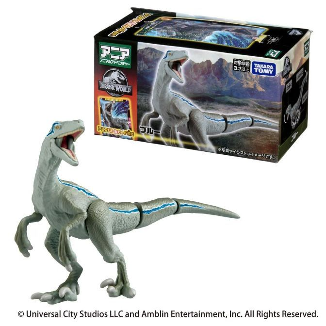  Blue raptor toy with packaging. Dinosaur figure has blue stripe detail.