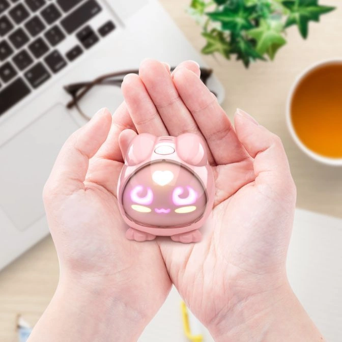  Pink, glowing, cartoon-like toy in hands. Heart and crescent moon shapes on screen.