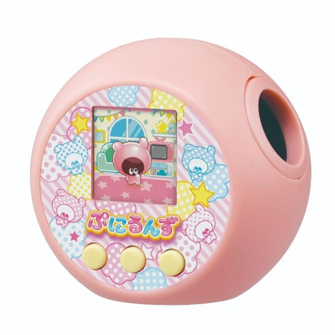 Pink virtual pet toy with screen showing a cartoon bear in a room, and three buttons below.