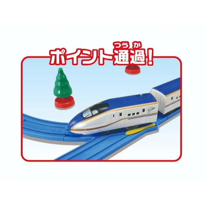  Toy bullet train on a blue track with a tree and red signal.