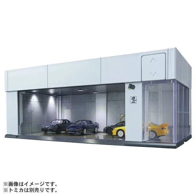 Toy car garage with four model cars inside, including a yellow sports car in a display case.