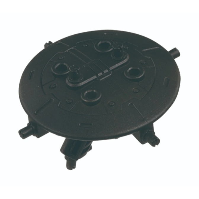  Black UFO-shaped toy with protruding pegs and circular details on top.