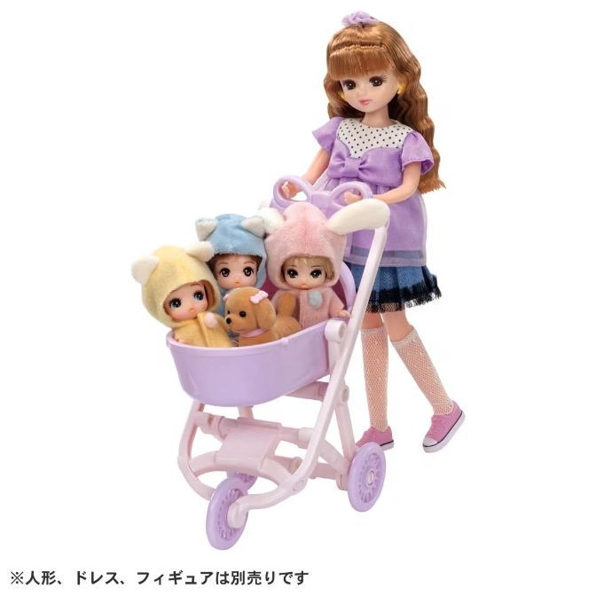 Doll pushing stroller with baby dolls and a toy dog.