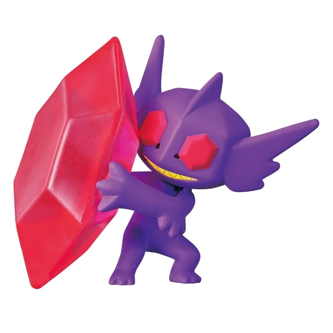 Purple Sableye toy holding a large red gem, with pointy ears and a mischievous grin.