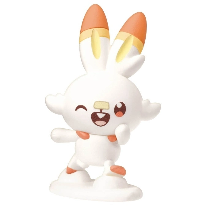 Scorbunny toy figure winking, with orange ears and feet, standing on a white base.