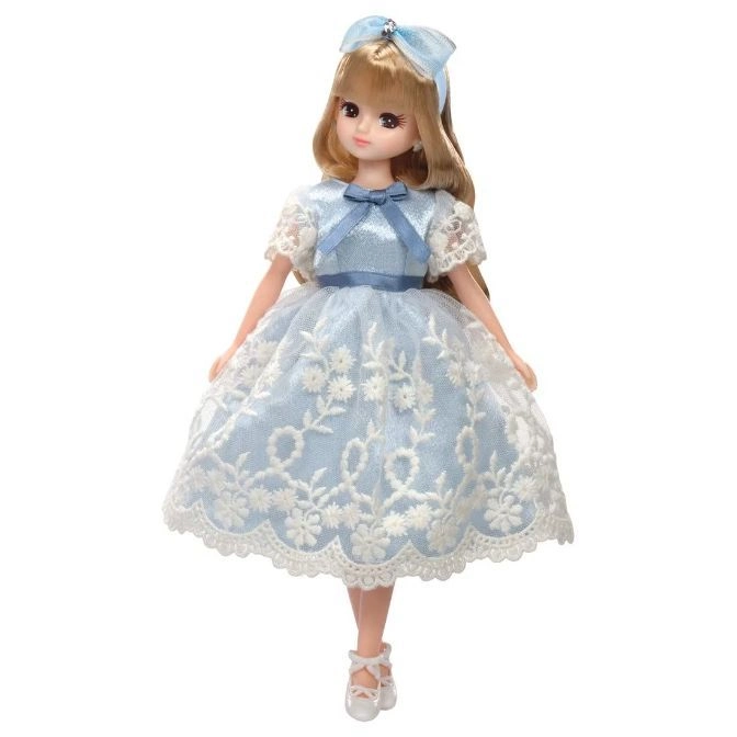 Blonde doll in blue dress with white lace and matching bow.