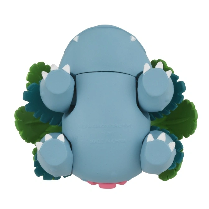  Blue Ivysaur toy lying on its back with green leaves around it.