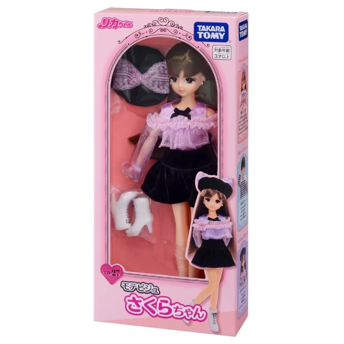 Licca-chan doll in a pink box, wearing a purple top, black skirt, hat, and white boots.