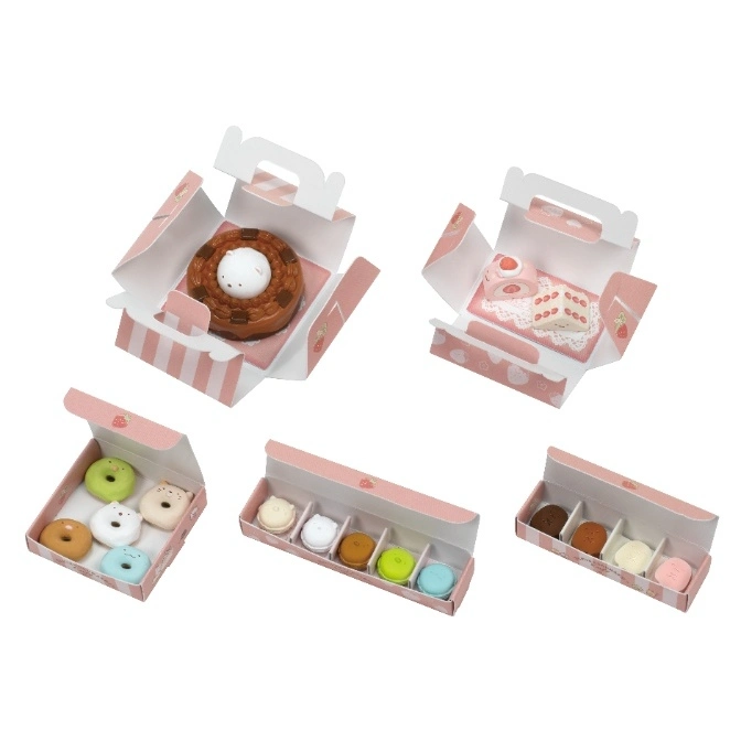  Miniature toy desserts in pink strawberry-themed boxes: cake, donuts, and macarons.