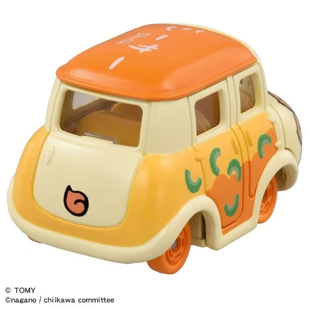  Orange and cream toy car with cartoon face and green accents.