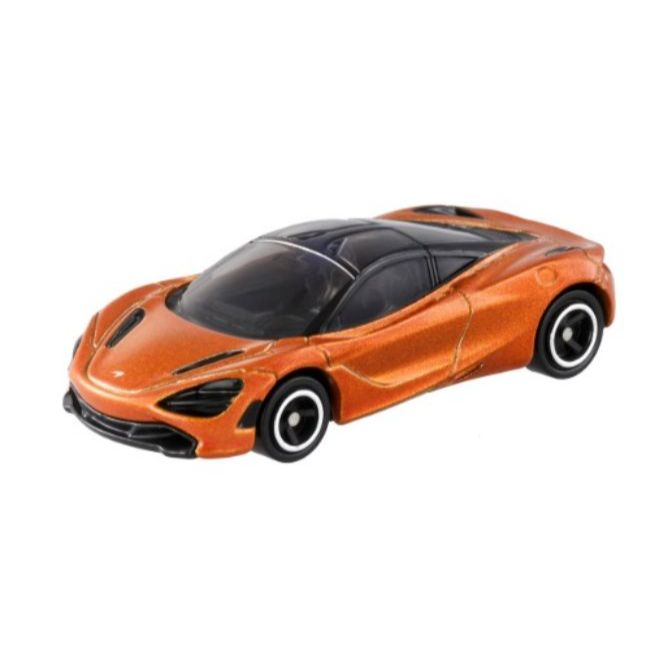 Orange toy McLaren 720S with black roof and white-rimmed wheels.