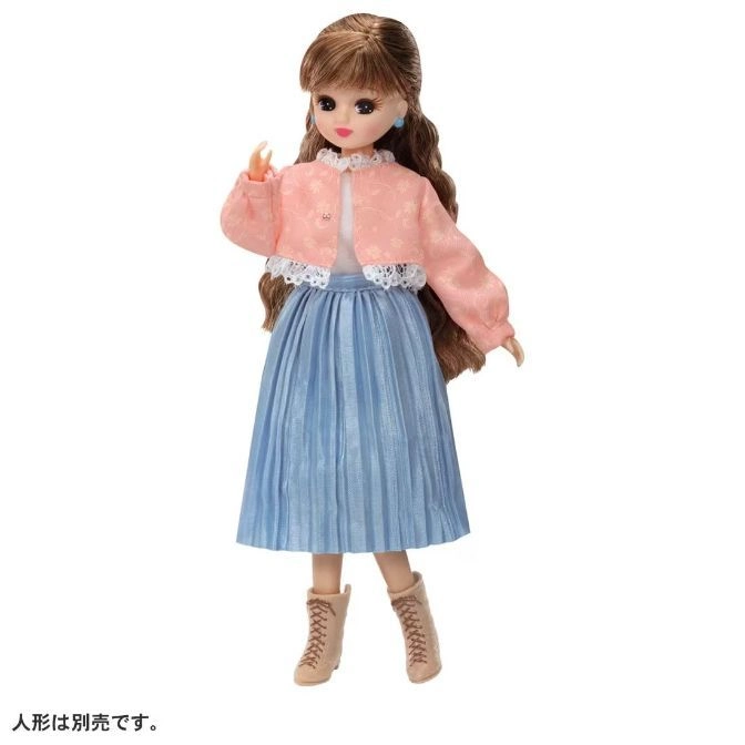  Doll with brown hair, pink jacket, blue skirt, and tan boots.